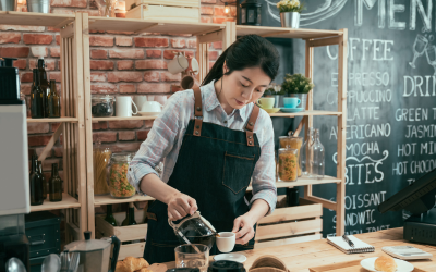 woman pouring coffee in a coffee shop - embracing change at work