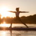 woman doing a yoga pose on a paddle board at sunset on a lake - how to say yes to doing what you want